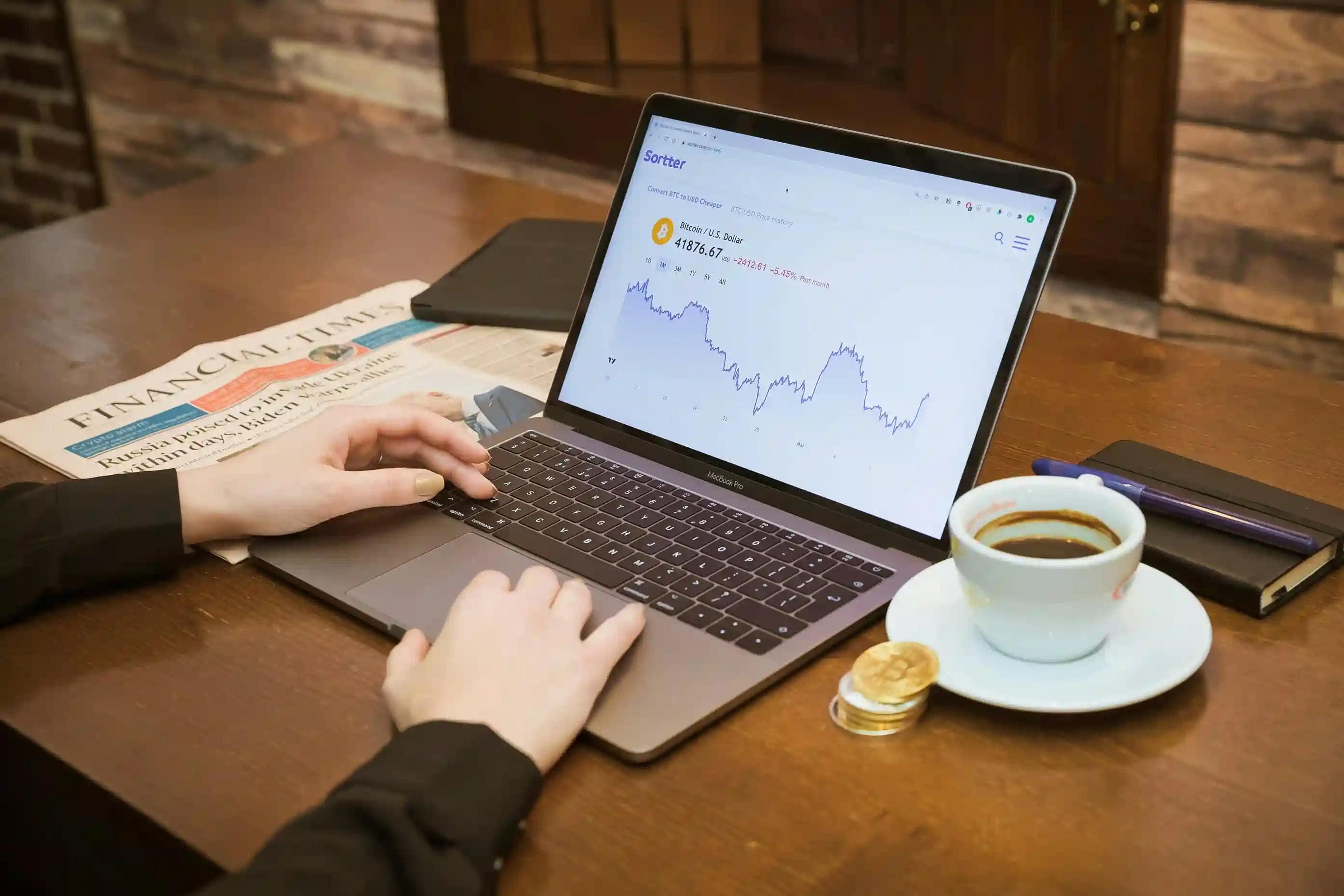 Prop firm trader reviewing account performance and market trends on a laptop dashboard