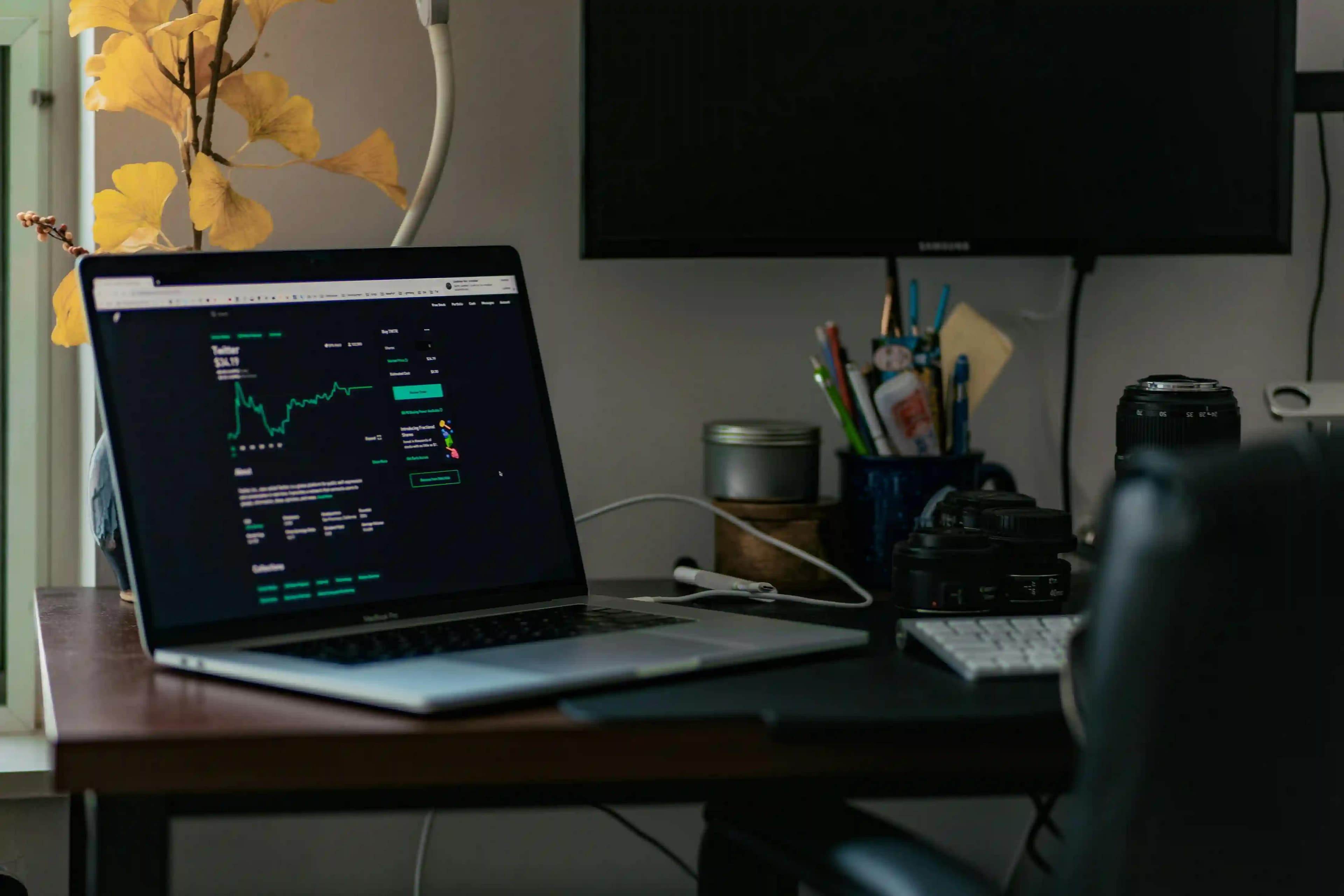 Prop firm trading dashboard displayed on laptop in a professional workspace setup
